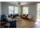 Living room with hardwood floors, comfy seating, and large windows at 20880 W Wycliff Ct, Buckeye, AZ 85396