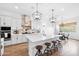 Modern kitchen with white cabinets, stainless steel appliances, and large island at 28722 N 133Rd N Ln, Peoria, AZ 85383