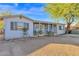 Single-story home with a covered porch, rocking chairs, and desert landscaping at 2931 E Danbury Rd, Phoenix, AZ 85032