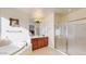 Elegant bathroom with soaking tub, vanity, and glass shower at 30855 N 138Th Ave, Peoria, AZ 85383