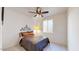 Cozy bedroom with ceiling fan and large window at 30855 N 138Th Ave, Peoria, AZ 85383