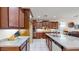 Well-equipped kitchen with granite countertops and rich wood cabinets at 30855 N 138Th Ave, Peoria, AZ 85383
