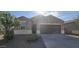 One-story house with brown garage door and desert landscaping at 36375 W Picasso St, Maricopa, AZ 85138