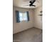 Bright bedroom with window, ceiling fan, and carpet at 3753 S Mill Ave, Tempe, AZ 85282