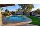 Relaxing kidney-shaped pool surrounded by lush landscaping at 5239 E Waltann Ln, Scottsdale, AZ 85254