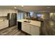 Modern kitchen with white cabinets, stainless steel appliances, and an island at 5625 W Grovers Ave, Glendale, AZ 85308