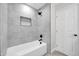 Modern bathroom with gray tile and a shower/tub combo at 6710 N 82Nd Dr, Glendale, AZ 85303