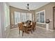 Bright dining room features a wooden table with chairs and large windows with plantation shutters at 7075 W Noble Prairie Way, Florence, AZ 85132