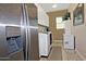 Bright laundry room with washer, dryer, and ample cabinet space at 7075 W Noble Prairie Way, Florence, AZ 85132