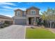 Two-story house with gray siding, a large driveway, and a landscaped lawn at 766 N 153Rd Ave, Goodyear, AZ 85338