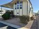 Attractive manufactured home with carport and landscaping at 7750 E Broadway Rd # 822, Mesa, AZ 85208