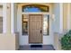 Front entrance with a brown door and sidelights, welcoming entryway at 8931 E Calypso Ave, Mesa, AZ 85208