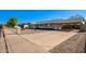 Front view of the house with driveway, landscaping, and a walkway at 941 E 10Th Pl, Mesa, AZ 85203