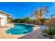 Inviting kidney-shaped pool with a large surrounding patio at 941 E 10Th Pl, Mesa, AZ 85203