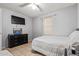 Bright bedroom with a double bed, dresser, and window coverings at 10096 N 63Rd Ave, Glendale, AZ 85302