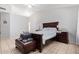 Primary bedroom with dark wood furniture and tiled floors at 10096 N 63Rd Ave, Glendale, AZ 85302