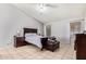 Spacious bedroom with dark wood furniture and tiled floors at 10096 N 63Rd Ave, Glendale, AZ 85302