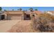 House exterior with a two-car garage and desert landscaping at 10096 N 63Rd Ave, Glendale, AZ 85302