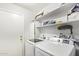 Laundry room with washer, dryer, and shelving at 10096 N 63Rd Ave, Glendale, AZ 85302