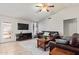 Spacious living room with leather couches and a large TV at 10096 N 63Rd Ave, Glendale, AZ 85302