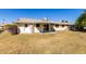 View of the home's back elevation and grassy backyard at 10411 W Prairie Hills Cir, Sun City, AZ 85351