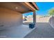 Covered patio with fire pit, overlooking a gravel backyard at 10448 E Verbina E Ln, Florence, AZ 85132