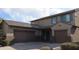 Two-story house with taupe exterior, two-car garage, and landscaping at 10551 W Crown King Rd, Tolleson, AZ 85353