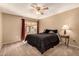 Bedroom with a queen-sized bed, nightstand, and access to a sunroom at 10709 W Clair Dr, Sun City, AZ 85351