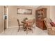 Cozy dining area with wooden table and chairs, and a china cabinet at 10709 W Clair Dr, Sun City, AZ 85351