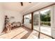 Bright sunroom with tile floors and sliding glass doors leading to the backyard at 10709 W Clair Dr, Sun City, AZ 85351