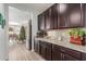 Kitchen with dark wood cabinets, granite counters, and wine rack at 1358 N St Paul --, Mesa, AZ 85205