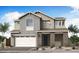 Two-story home with gray siding, brick accents, and a two-car garage at 1487 E Eleana Ln, Gilbert, AZ 85298