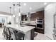 Modern kitchen with dark cabinetry, quartz countertops, and island at 19615 W San Miguel Ave, Litchfield Park, AZ 85340