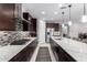 Modern kitchen with dark cabinetry, quartz countertops, and island at 19615 W San Miguel Ave, Litchfield Park, AZ 85340