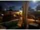 Night view of backyard patio with built-in bar and firepit at 20235 N 63Rd Dr, Glendale, AZ 85308