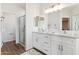 Elegant bathroom with double vanity, large mirror, and a walk-in shower at 20236 W Highland Ave, Litchfield Park, AZ 85340