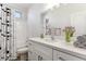 Clean bathroom with white vanity, bathtub, and patterned shower curtain at 20236 W Highland Ave, Litchfield Park, AZ 85340