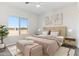 Bright bedroom with a queen-size bed and large window at 20236 W Highland Ave, Litchfield Park, AZ 85340