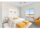 Serene bedroom with a queen bed, and two ottomans, plus a window seat at 20236 W Highland Ave, Litchfield Park, AZ 85340