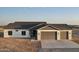 New home exterior with a two car garage and desert landscaping at 20236 W Highland Ave, Litchfield Park, AZ 85340