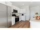 Modern kitchen with stainless steel appliances and white cabinetry at 20236 W Highland Ave, Litchfield Park, AZ 85340