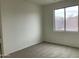 Simple bedroom with carpet flooring and a large window at 22130 N Van Loo Dr, Maricopa, AZ 85138