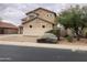 Two-story house with a landscaped yard, showcasing the side elevation at 22130 N Van Loo Dr, Maricopa, AZ 85138