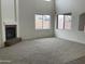 Spacious living room with a fireplace and large windows at 22130 N Van Loo Dr, Maricopa, AZ 85138