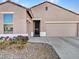 One story home with a two-car garage and security door at 22665 W Antelope Trl, Buckeye, AZ 85326