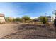 Backyard with desert landscaping, gravel and a wrought iron fence at 26783 W Zachary Dr, Buckeye, AZ 85396