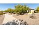 Curved concrete pathway with desert landscaping and bench at 27437 W Yukon Dr, Buckeye, AZ 85396