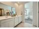 Double vanity bathroom with large mirror and access to bedroom at 36580 W Giallo Ln, Maricopa, AZ 85138