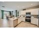 Eat-in kitchen featuring stainless steel appliances and island at 36580 W Giallo Ln, Maricopa, AZ 85138