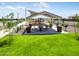 Community picnic area with shaded tables and playground view at 36580 W Giallo Ln, Maricopa, AZ 85138